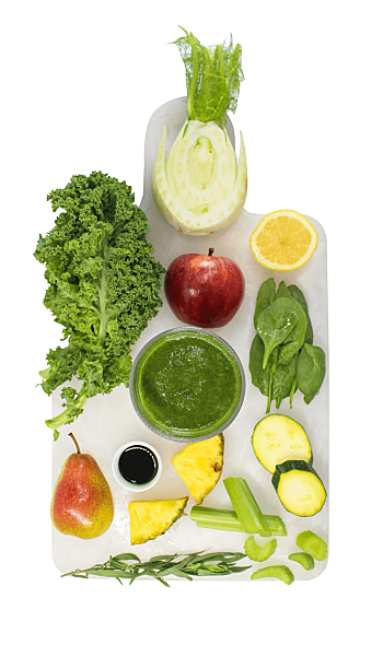 Top view image of leafy greens and other ingredients on a white chopping board found in the Love Craft Smoothie by Living Farmacy Inc., smoothie subscription Canada.