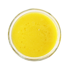 Top view of yellow frozen craft smoothie in a glass by Living Farmacy.