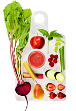 Top view image of fruits and vegetables on a white chopping board.